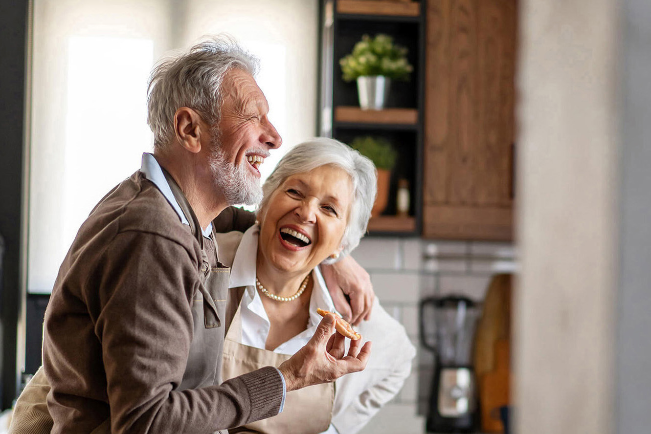 Happy senior couple having fun in the kitchen together